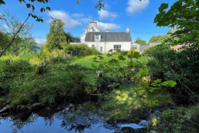 Traditional farm cottage with woodburner by stream